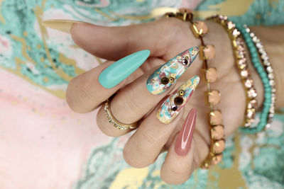 Woman showing nail art on table