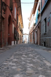 Empty alley amidst buildings in city