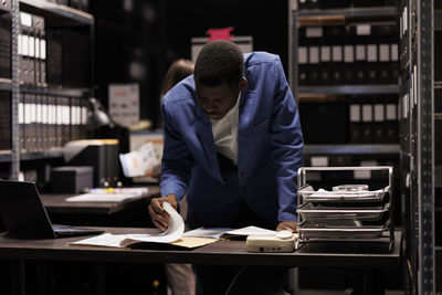 Side view of man working at office