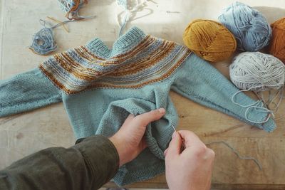 High angle view of hands working on table