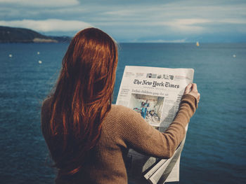 Rear view of woman against sea