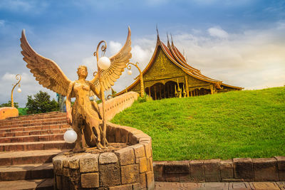 Statue of temple against cloudy sky