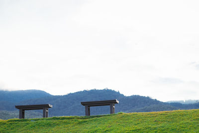 Built structure on field against sky