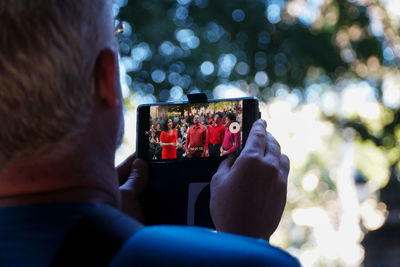 Rear view of man photographing