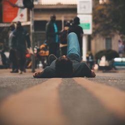 Rear view of people walking on street