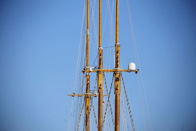 Low angle view of sailboat against clear blue sky