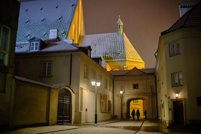 Street amidst buildings in city at night