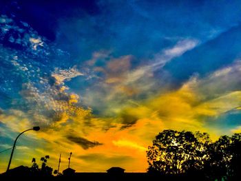 Low angle view of silhouette trees against sky at sunset