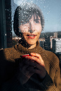 Portrait of woman in glass window