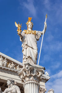 Low angle view of statue against cloudy sky