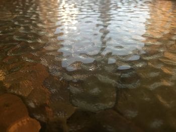 Full frame shot of raindrops on water