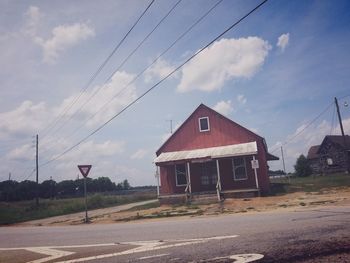 Road by building against sky