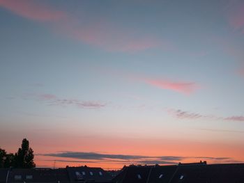 Silhouette city against sky during sunset