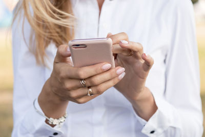 Midsection of woman using mobile phone
