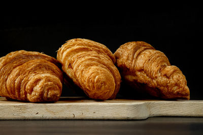 Close-up of bread on table against black background