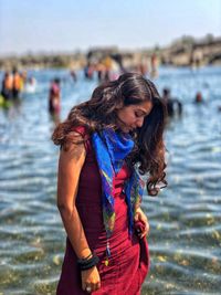 Midsection of woman standing in sea