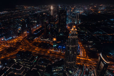 High angle view of city lit up at night