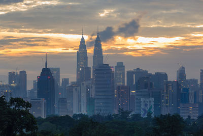 View of buildings against cloudy sky during sunset