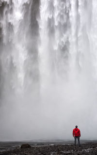 Man standing on waterfall