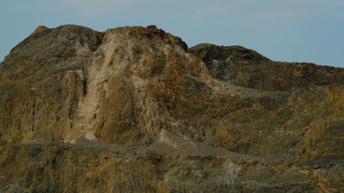 Low angle view of rock formation against sky