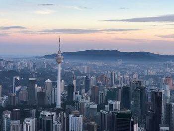 Aerial view of buildings in city at sunset