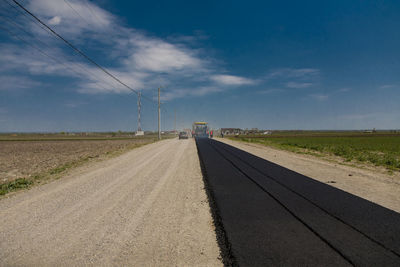 Road on field against sky