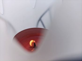 High angle view of lit candle on table