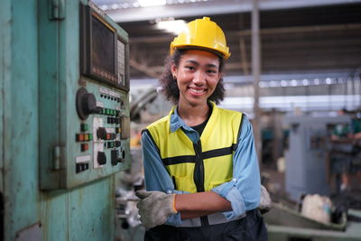 Portrait of young man working in factory