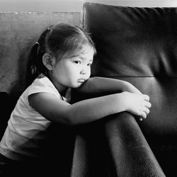 Young woman sitting on sofa at home