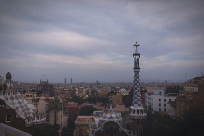 Cityscape against cloudy sky