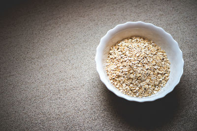 Close-up of oat flakes in bowl on table