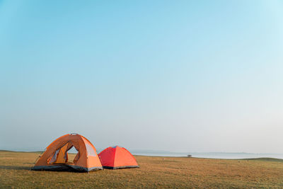 Tent on beach against clear sky