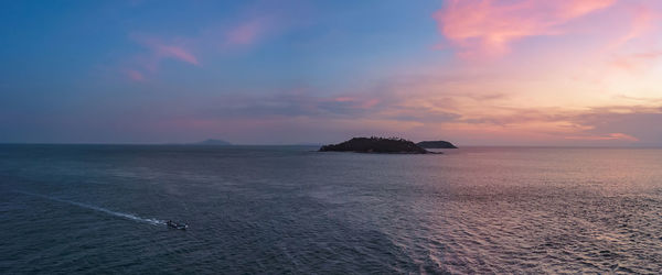 Scenic view of sea against sky at sunset