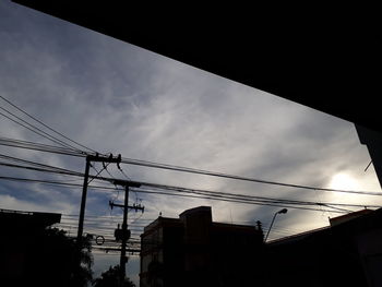 Low angle view of cables against sky