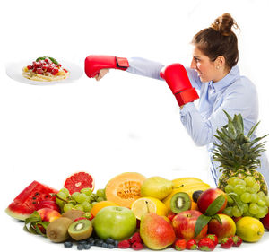 Young businesswoman practicing boxing by food against white background