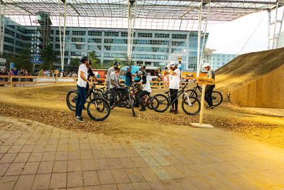 People riding bicycles on street in city