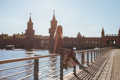 Bridge over river against buildings in city