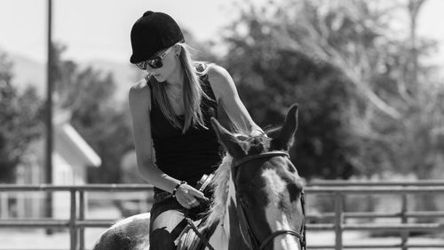 Portrait of young woman riding horse