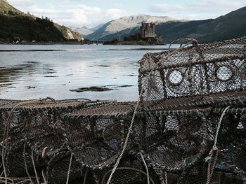 Crab pots at lake against sky