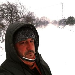 Portrait of man in winter against sky