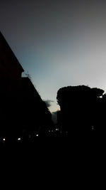 Silhouette built structures against clear sky