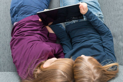 High angle view of woman relaxing on sofa