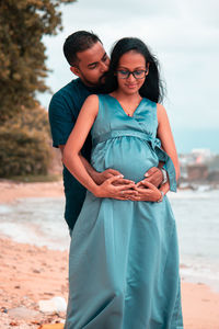 Happy couple standing on beach