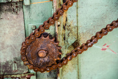 Close-up of rusty gear and chain