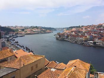 High angle view of townscape by sea against sky
