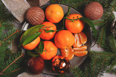 Citrus fruits oranges with christmas decorations on white table 