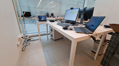 Empty chairs and tables on tiled floor