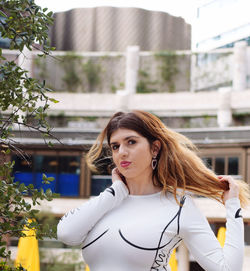 Portrait of young woman standing outdoors