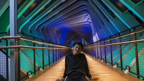 Portrait of relaxation man sitting on footbridge