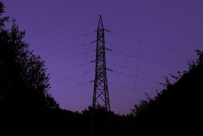 Low angle view of silhouette electricity pylon against sky during sunset